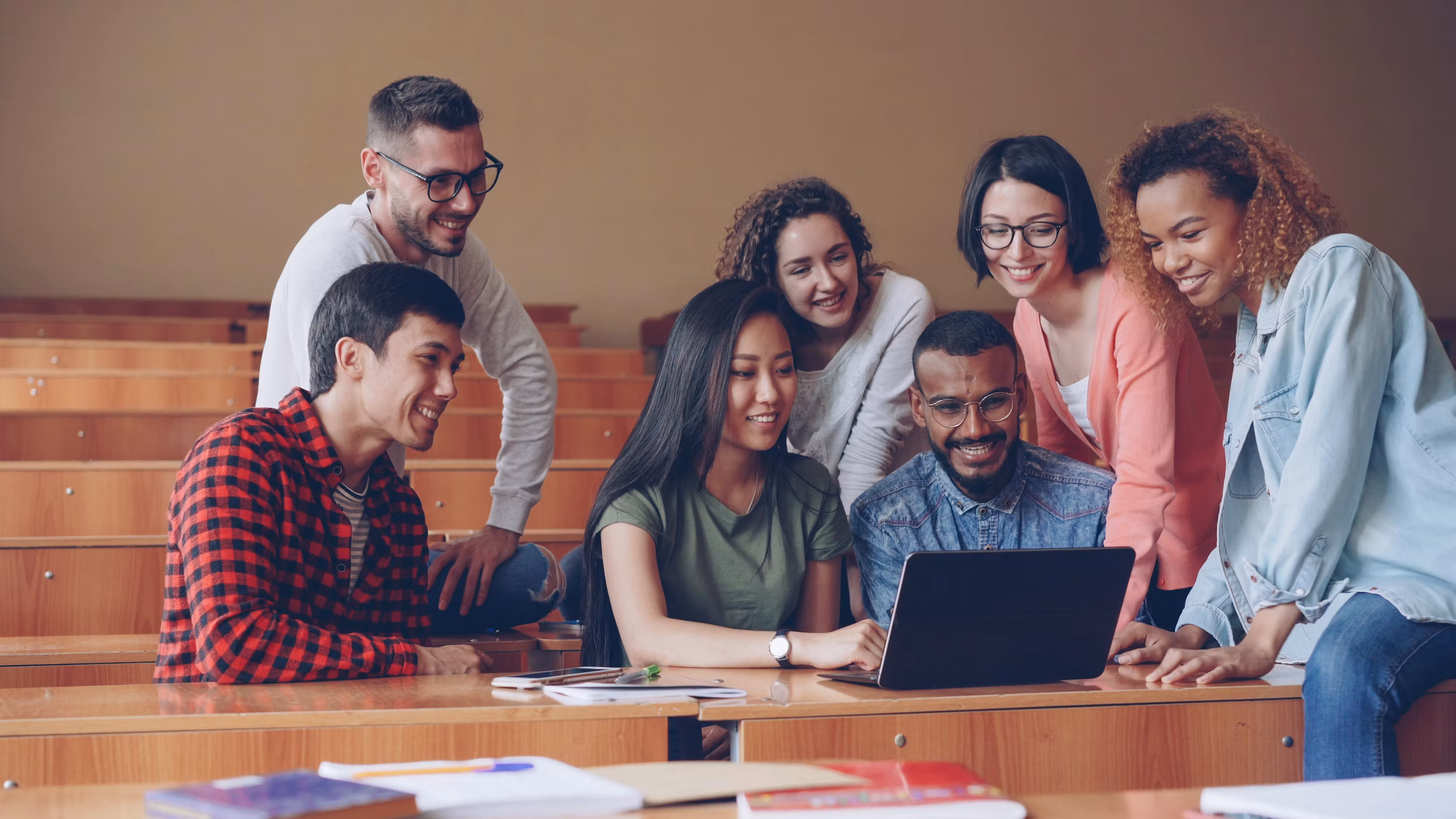 A team learning together around a laptop